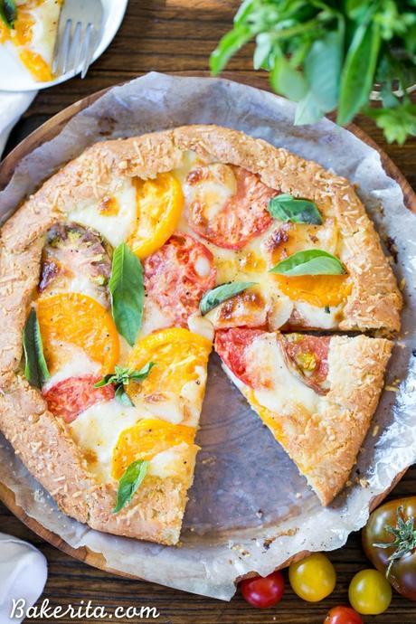 This Mozzarella Heirloom Tomato Galette showcases beautiful heirloom tomatoes bubbling with melted mozzarella cheese, all tucked into a gluten-free + grain-free Parmesan crust. 