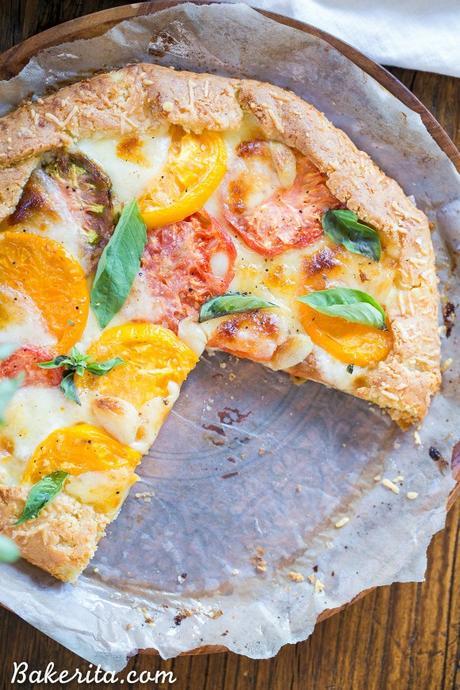 This Mozzarella Heirloom Tomato Galette showcases beautiful heirloom tomatoes bubbling with melted mozzarella cheese, all tucked into a gluten-free + grain-free Parmesan crust. 