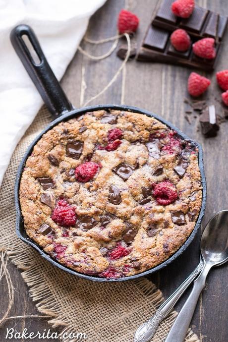 This Raspberry Chocolate Chunk Skillet Cookie is an easy, one bowl recipe loaded with fresh raspberries and dark chocolate chunks. This gooey skillet cookie is gluten-free, Paleo, and refined sugar free.