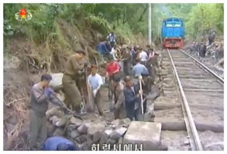 A railway trackbed is repaired as part of flood relief work in North Hamgyo'ng Province (Photo: Korean Central Television).