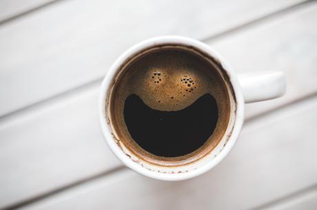 A cup of coffee that appears to be smiling
