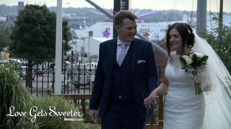 bride and groom walking for photos and video in st nicholas grounds liverpool docks wedding