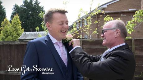 groom having buttonhole put on before liverpool wedding