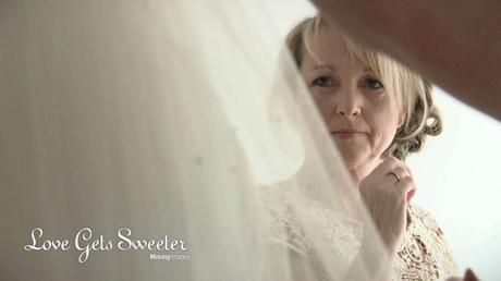 mother of the bride watching daughter get her veil on before getting married in liverpool