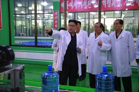 Kim Jong Un tours a bottling section at the Ryongaksan Spring Water Factory in Pyongyang in a photo which appeared top-center on the front page of the September 30, 2016 edition of the WPK daily organ Rodong Sinmun (Photo: Rodong Sinmun).