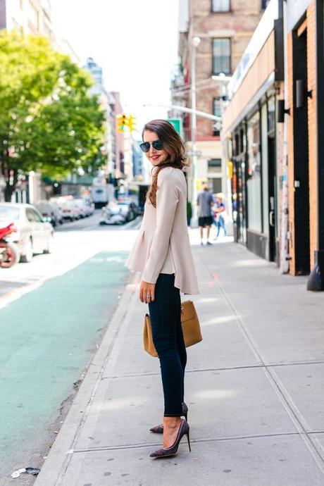 Amy Havins wears a pink peplum blouse with dark skinny jeans.
