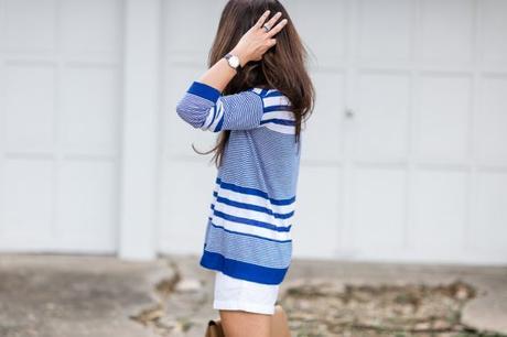 Amy Havins wears a blue and white sweater with white shorts.