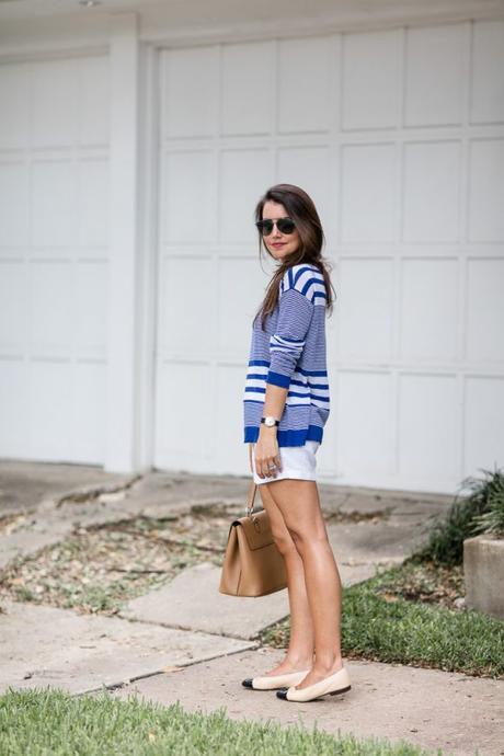 Amy Havins wears a blue and white sweater with white shorts.