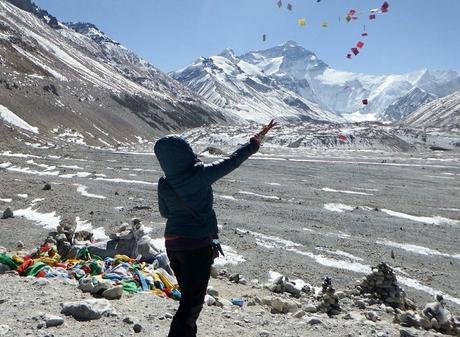Throwing prayer flags in the air for good luck before Mt. Everest in Tibet.