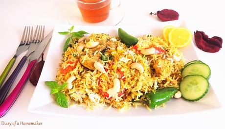 nawabi-biryani-Indian-cuisine-main-dish-rice-tomatoes-garam-masala-red-pepper-fried-onions-kewra-screwpine-cashews-almonds-sesame-seeds-lemon-mint-green-pepper-cloves-cinnamon-chicken-pilaf-entree-