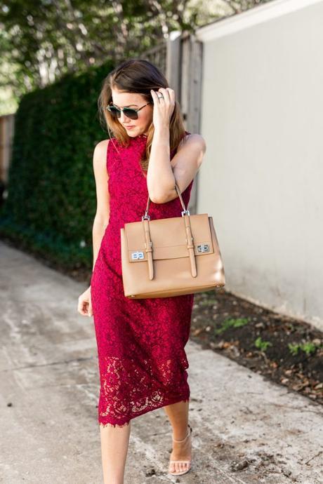 Amy Havins wears a red lace midi Shoshanna dress.