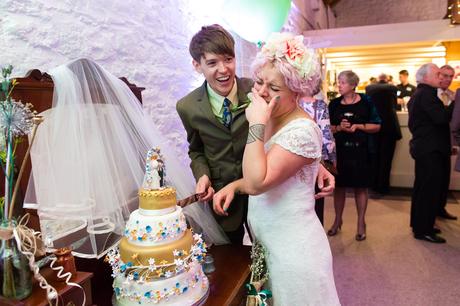 Bride laughing during cake cutting at East Riddlesden Hall
