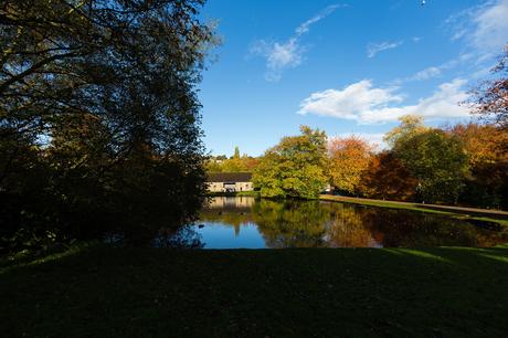 Exterior photograph during autumn at East Riddlesden Hall Airedale Barn by lake with reflections