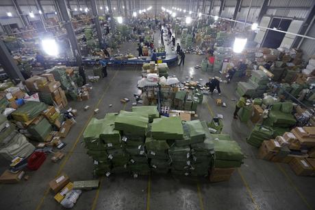 A general view shows employees sorting packages along a conveyor belt at a hub of ZTO Express Delivery company in Wuhan
