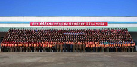 Commemorative photograph of Kim Jong Un with officials and employees of the August 25 Fishery Station in photos which appeared on the bottom of page 2 of the November 20, 2016 edition of the WPK daily newspaper Rodong Sinmun (Photo: Rodong Sinmun).