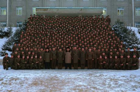 Kim Jong Un poses for a commemorative photograph with commanders, staff officers and service members of the headquarters element of KPA Large Combined Unit #380 in a photo which appeared on the cover of the November 25, 2016 edition of the WPK daily organ Rodong Sinmun (Photo: Rodong Sinmun).