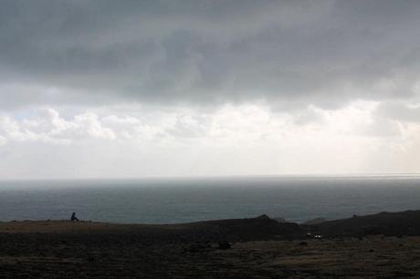 dyrholaey-cliff-iceland-person-sitting