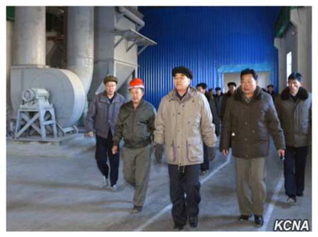 Pak Pong Ju (center in black hat and gray parka) tours the Komdok Mining Industry Complex with senior party and government officials (Photo: KCNA).