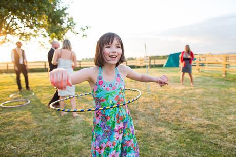 Girl playing hula hoop in sunset Tips for Children at Weddings
