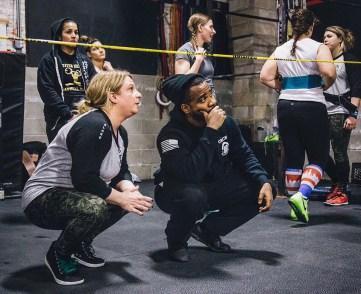 Crossfit Prospect Heights owner and trainer Maillard Howel working with student Lorin Blake.