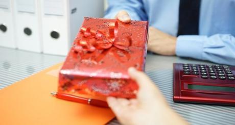 businessman is receiving a gift from partner