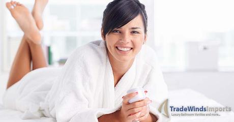 Pretty young woman in bathrobe looking at camera