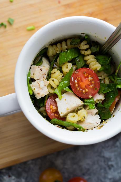 This pesto chicken mug pasta cooks up in the microwave in under 10 minutes for an easy and healthy lunch, dinner for one, or a dorm room meal.