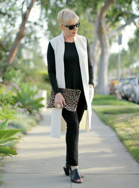 ivory sweater vest over black