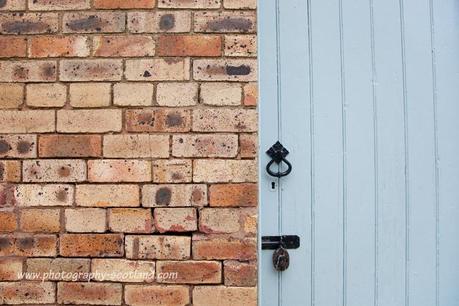 Photo - blue door painted and brick wall