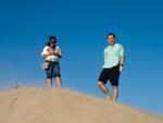 Nicole and Brett on the peak of a sand dune