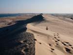 Travis behind a sand dune