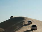 Land Cruiser convoy ascending a dune