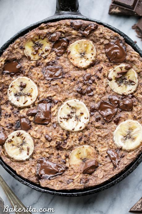 This easy Chocolate Chunk Banana Baked Oatmeal is a delicious twist on classic oatmeal - you'll definitely want to start your day with a serving of this gluten-free + vegan breakfast! This healthier oatmeal has no added sweetener; it's sweetened entirely with ripe banana and chocolate chunks.
