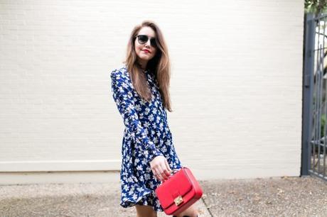 Amy havins wears a navy and white floral print shoshanna long sleeve dress with over the knee boots.