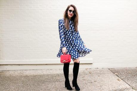 Amy havins wears a navy and white floral print shoshanna long sleeve dress with over the knee boots.