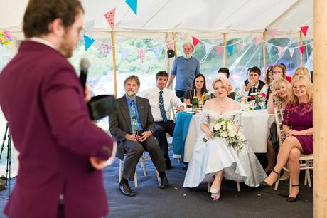 Bride in blue dress watching speech Derwentwater Independent Hostel Wedding