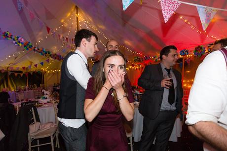 Guest laughs and covers face during the party Derwentwater Independent Hostel Wedding
