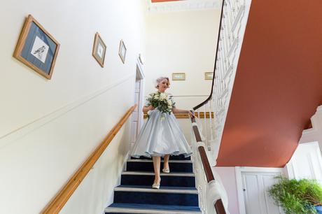 Bride walks down stairs