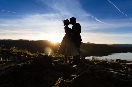 Silhouette of bride and groom kissing in the sunset Derwentwater Independent Hostel Wedding