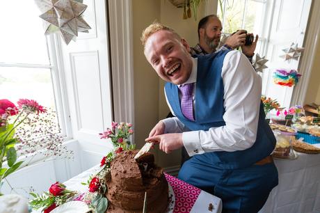 Laughing by the cake at Derwentwater Independent Hostel Wedding