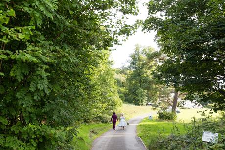 Bride & groom walk up the lane outside of Derwentwater Independent Hostel Wedding