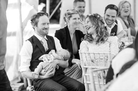 Guests laughing during wedding speeches