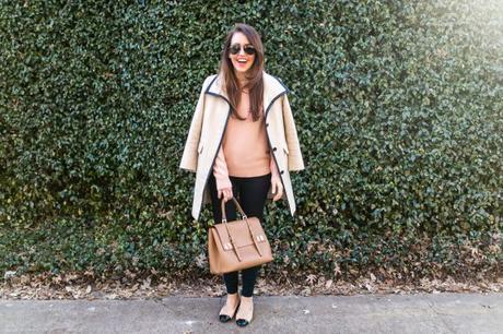 Amy Havins wears a blush sweater paired with skinny jeans and ballet flats.