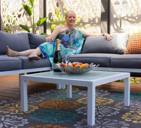 Add a pop of color using rugs and cushions to your outdoor living space