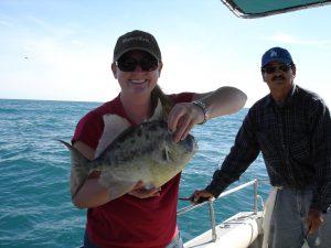 FisherChic holding a triggerfish in Puerto Penasco