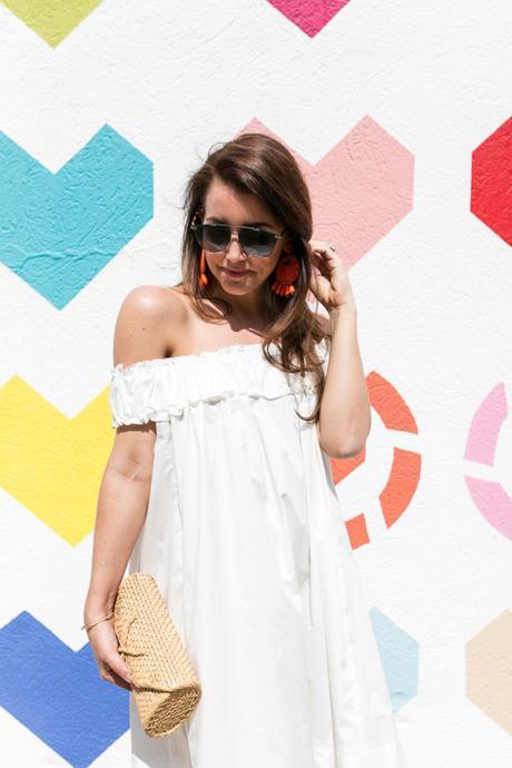 Amy Havins wears a white off the shoulder dress.