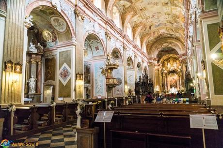 Interior of Velehrad basilica has ornately painted ceilings and a checkerboard floor