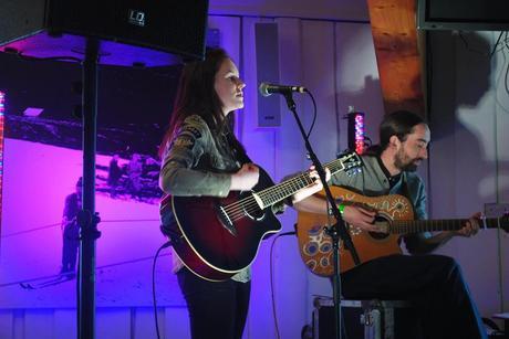 Image may contain: 1 person, on stage and playing a musical instrument