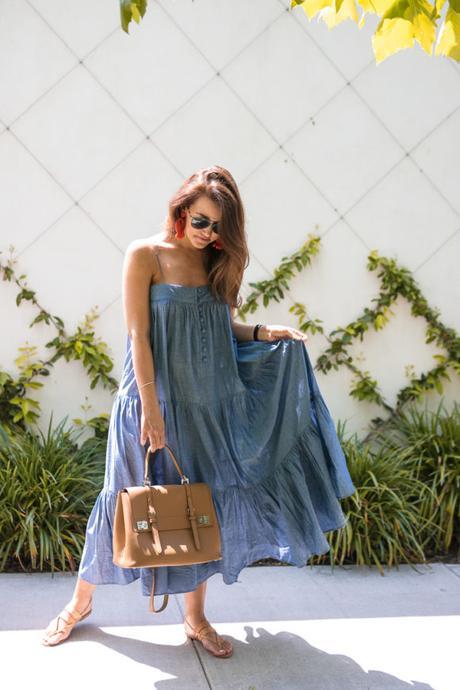 Amy Havins wears a denim tiered maxi dress with flats.