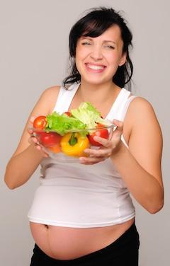 pregnant woman with bowl of vegetables